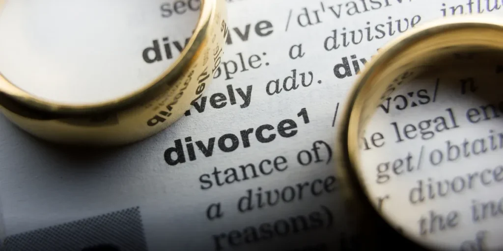 Two wedding bands near the word divorce representing How Long Does Divorce Take in Arkansas