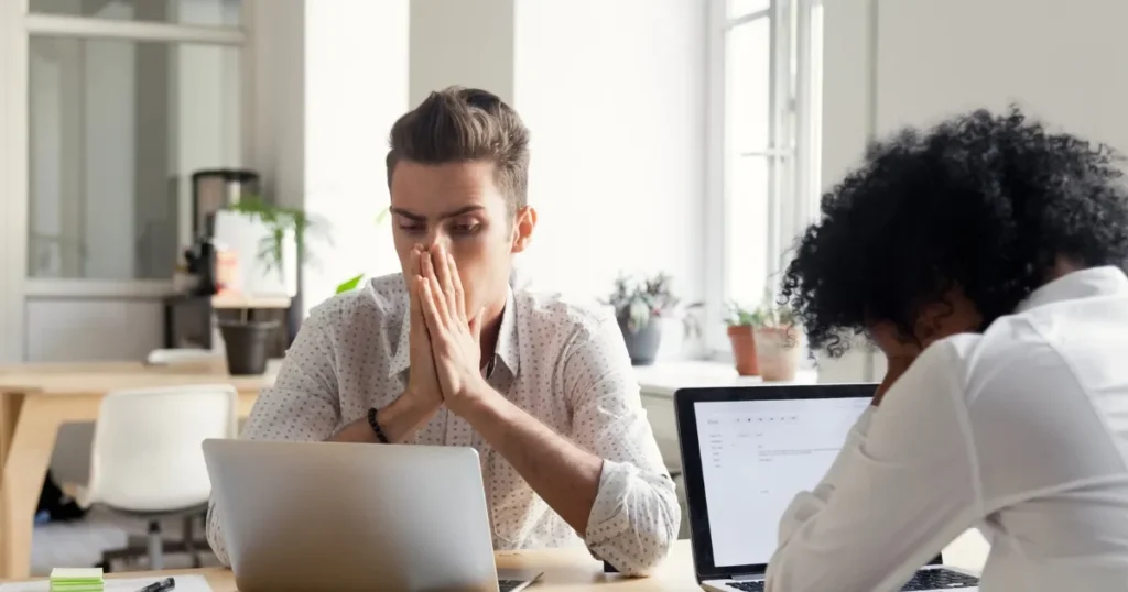 Concerned man at his laptop trying to figure out the benefits of Debt Consolidation vs Bankruptcy