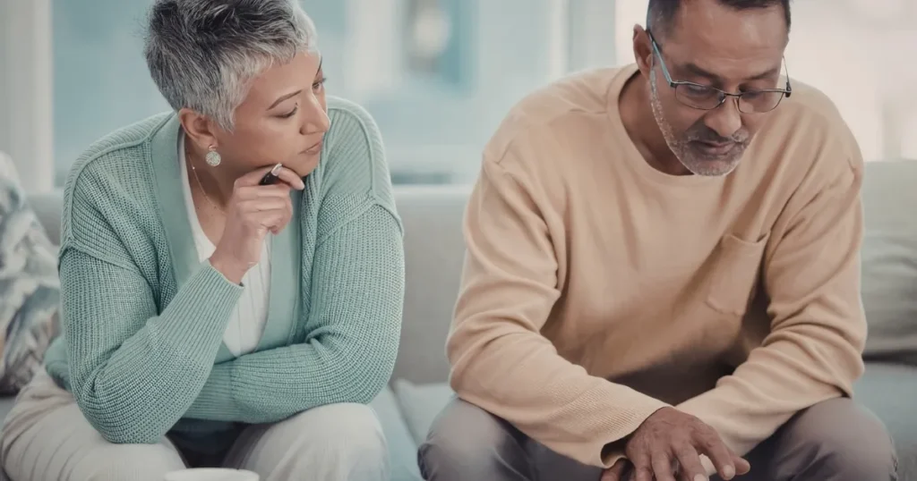 couple in their fifties signing gray divorce paperwork